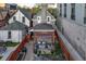 This backyard features a cozy pergola with stylish seating and a brick-paved patio, perfect for entertaining at 1729 N Clarkson St, Denver, CO 80218