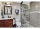 Updated bathroom with glass-enclosed shower, granite counter, and modern fixtures at 1729 N Clarkson St, Denver, CO 80218