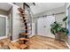 Charming bedroom with wood floors, modern staircase and large plant at 1729 N Clarkson St, Denver, CO 80218