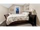 Serene bedroom showcases a bed with a botanical duvet, complemented by a nightstand and soft lighting at 1729 N Clarkson St, Denver, CO 80218