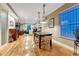 Bright dining area with stylish lighting, a wooden table, and views into the living space at 1729 N Clarkson St, Denver, CO 80218