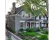 Charming gray two-story home with a covered front porch and well-maintained landscaping at 1729 N Clarkson St, Denver, CO 80218