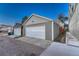 Detached two car garage with white doors and gray siding, offering secure parking and storage at 1729 N Clarkson St, Denver, CO 80218