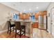Bright kitchen features wooden cabinets, stainless steel appliances, and breakfast bar with granite countertops at 1729 N Clarkson St, Denver, CO 80218
