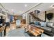 Open concept living room with hardwood floors, a comfortable sofa, and staircase at 1729 N Clarkson St, Denver, CO 80218