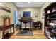 Charming home office with a sit-stand desk, lots of natural light, and a rustic bookcase at 1729 N Clarkson St, Denver, CO 80218