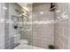 Modern shower with gray tiled walls, pebble floor and glass enclosure at 1729 N Clarkson St, Denver, CO 80218