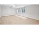 Finished basement with two basement windows, light colored wood-look flooring, and white walls at 467 Harrison St, Denver, CO 80206