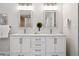 Modern bathroom with double sink vanity, well lit mirrors, and ample storage space at 467 Harrison St, Denver, CO 80206