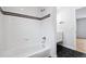 Bright bathroom showcasing a white tiled shower-tub combo and modern fixtures at 467 Harrison St, Denver, CO 80206