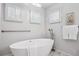 Bright soaking tub area with white marble tile floor and open window at 467 Harrison St, Denver, CO 80206