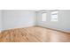 Bright bedroom featuring hardwood floors, two windows, and fresh white walls at 467 Harrison St, Denver, CO 80206