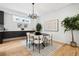 Dining room featuring a modern light fixture, large window, and views into the kitchen at 467 Harrison St, Denver, CO 80206