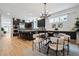 Open-concept dining area features a contemporary chandelier, dining table, and seamless flow to kitchen at 467 Harrison St, Denver, CO 80206