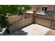 Exterior featuring a balcony, stone accents, garage and enclosed patio area at 467 Harrison St, Denver, CO 80206