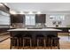 Spacious kitchen island with a white countertop and seating, complemented by sleek dark cabinetry and modern fixtures at 467 Harrison St, Denver, CO 80206