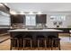 Modern kitchen features a center island with seating and dark cabinets at 467 Harrison St, Denver, CO 80206