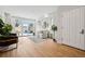 Light-filled living room with hardwood floors and sliding doors leading to the backyard at 467 Harrison St, Denver, CO 80206