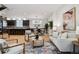 Spacious living room shows an open floorplan, kitchen with island seating, and comfortable living area at 467 Harrison St, Denver, CO 80206
