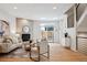 Bright living area with a stone fireplace, modern furniture, and sliding doors to the outdoor patio at 467 Harrison St, Denver, CO 80206