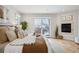 Cozy main bedroom boasts a fireplace, balcony access, and hardwood floors at 467 Harrison St, Denver, CO 80206
