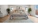 Comfortable main bedroom with large bed, neutral decor, hardwood floors, and large windows at 467 Harrison St, Denver, CO 80206