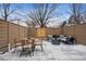 Private outdoor patio with stylish seating, dining set, and a modern fence for privacy at 467 Harrison St, Denver, CO 80206