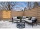 Cozy outdoor patio with cushioned seating, privacy fence, and a stylish round table, perfect for relaxing at 467 Harrison St, Denver, CO 80206