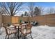 Inviting patio featuring wicker seating, round table, privacy fence and an outdoor space for entertainment at 467 Harrison St, Denver, CO 80206