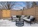 Cozy outdoor patio includes comfortable seating, a stylish table, and a modern privacy fence at 467 Harrison St, Denver, CO 80206