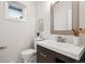 Small powder room features a modern vanity, updated fixture, and neutral decor at 467 Harrison St, Denver, CO 80206