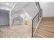 Modern staircase with wooden steps, black metal railing, and adjacent full wall mirror at 467 Harrison St, Denver, CO 80206