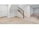 Staircase with wooden steps and black metal railing, adjacent to a doorway and white wall at 467 Harrison St, Denver, CO 80206