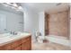 Bathroom with a marble countertop, wooden cabinets, bathtub, and shower at 15501 E 112Th Ave # 15C, Commerce City, CO 80022