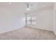 Large bedroom featuring soft carpet, white walls, and bright natural light from the dual window at 15501 E 112Th Ave # 15C, Commerce City, CO 80022