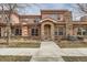 Exterior of a charming two-story home showcasing a stone accent wall, covered entryway, and tidy landscaping at 15501 E 112Th Ave # 15C, Commerce City, CO 80022