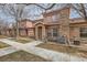 Charming exterior of a two-story home featuring a stone accent wall, covered entrance, and well-maintained landscaping at 15501 E 112Th Ave # 15C, Commerce City, CO 80022