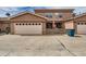 This home features a large garage and concrete parking pad at 15501 E 112Th Ave # 15C, Commerce City, CO 80022