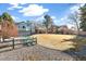 Expansive backyard featuring a spacious lawn, covered patio, and inviting outdoor seating area at 7193 S Newport Way, Centennial, CO 80112