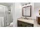 Well-lit bathroom featuring granite countertops and a glass-enclosed shower at 7193 S Newport Way, Centennial, CO 80112