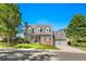 Charming two-story home with brick accents, a well-manicured lawn, and a two-car garage at 7193 S Newport Way, Centennial, CO 80112