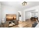 Cozy living room featuring light hardwood floors, white walls, and an open concept to the dining area at 7193 S Newport Way, Centennial, CO 80112