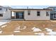 Home's back and side view, showing patio and yard at 9661 Ceylon St, Commerce City, CO 80022