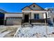 Two-story house with attached garage and snowy front yard at 9661 Ceylon St, Commerce City, CO 80022