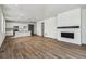 Open living room featuring a fireplace and kitchen island at 9661 Ceylon St, Commerce City, CO 80022