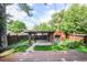 Backyard with a garden, deck, fence and a covered area behind the home at 321 S Gilpin St, Denver, CO 80209