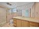 Bathroom featuring a tiled shower, a large mirror, and a vanity with storage at 321 S Gilpin St, Denver, CO 80209