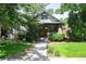 Charming brick home with a well-manicured front yard and inviting walkway at 321 S Gilpin St, Denver, CO 80209