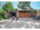 A detached garage with brick accents and a concrete driveway, plus outdoor bins at 321 S Gilpin St, Denver, CO 80209