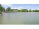 Scenic lake view featuring calm waters with a distant building and lush greenery at 321 S Gilpin St, Denver, CO 80209